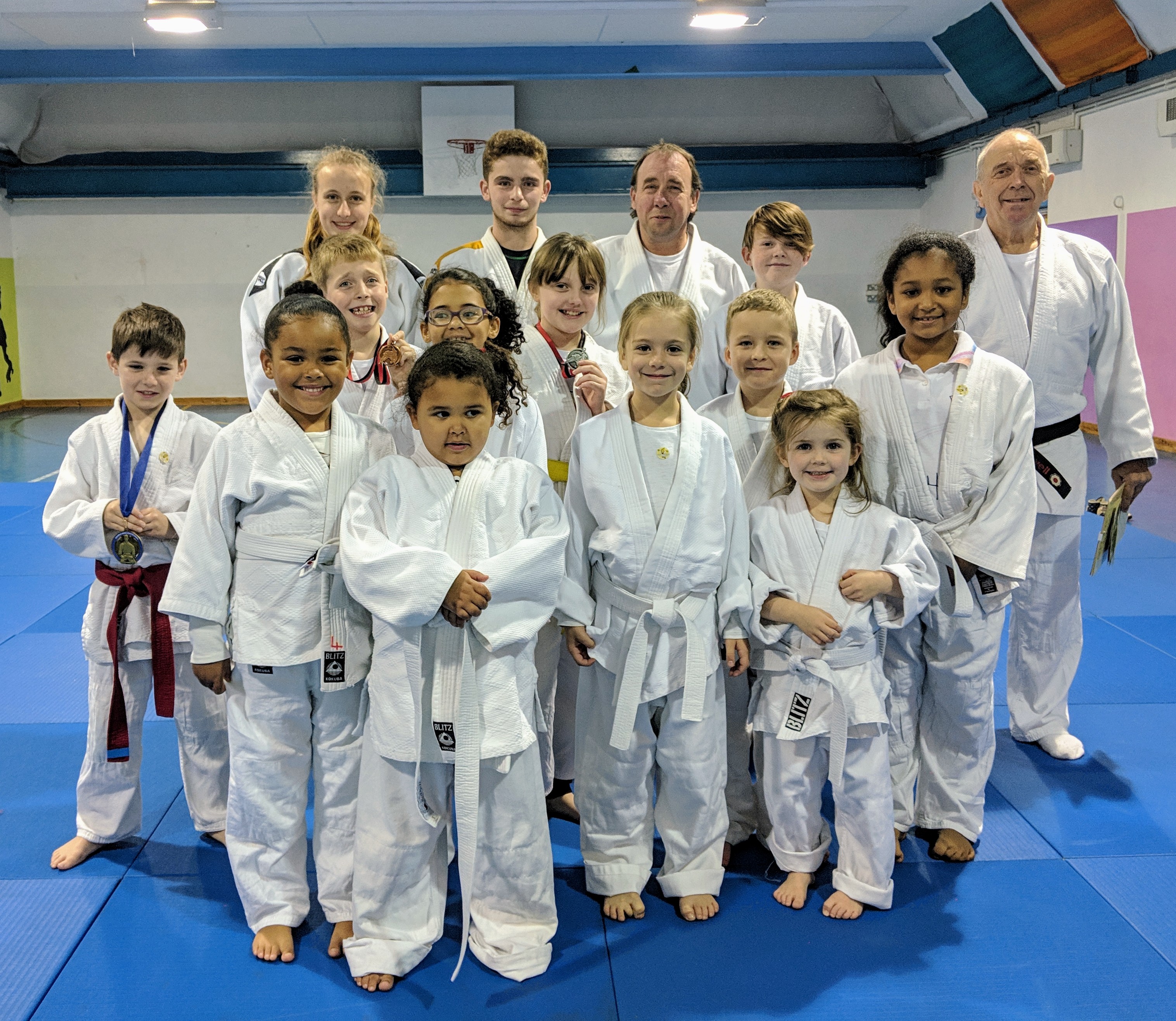 The judoka from Bromley Judo Academy's first mat standing with the coaches and junior coaches